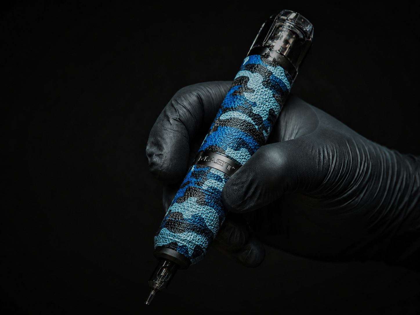 Close up of a professional tattoo machine in a dark studio